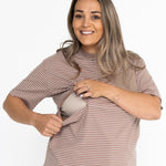 Smiling mum opening the two-way zip on the brown and white striped Mackenzie breastfeeding tee
