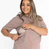 Smiling mum opening the two-way zip on the brown and white striped Mackenzie breastfeeding tee