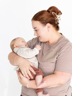Mum cuddling her baby in the brown and white striped Mackenzie breastfeeding tee by Milky Threads Co