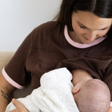 Mum breastfeeding her newborn in the brown and pink Indiana tee