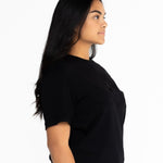 Side view of the black Indiana boyfriend tee showing the relaxed oversized fit