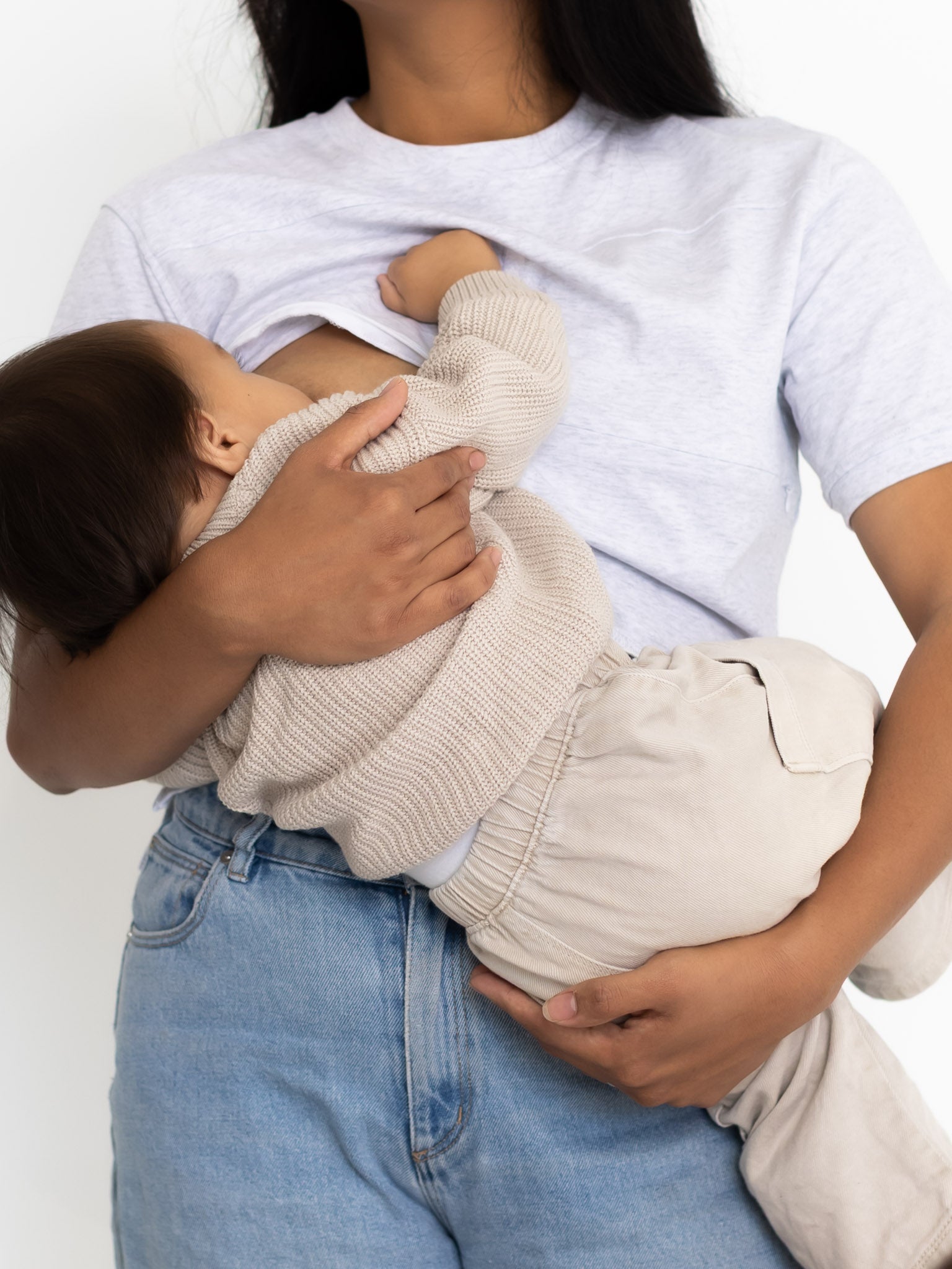 Mum breastfeeding her baby in the light grey Indiana breastfeeding tee by Milky Threads Co, worn with jeans