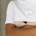 Close-up of the open two-way zip and Milky Threads Co flower logo on the grey Indiana tee