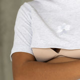 Close-up of the open two-way zip and Milky Threads Co flower logo on the grey Indiana tee