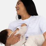 Laughing mum holding her baby during a feed in the grey Indiana tee