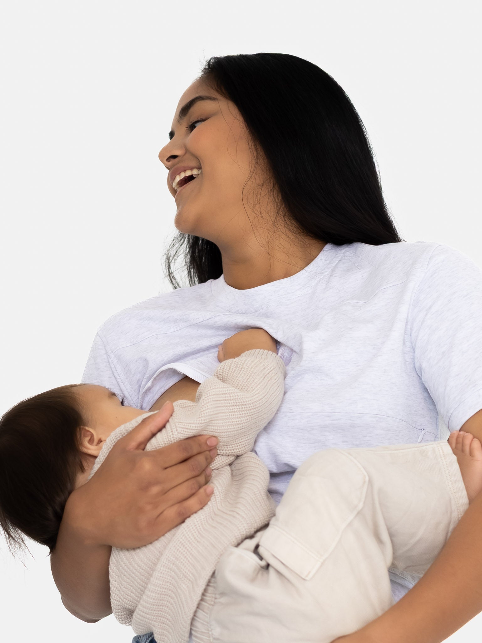 Laughing mum holding her baby during a feed in the grey Indiana tee