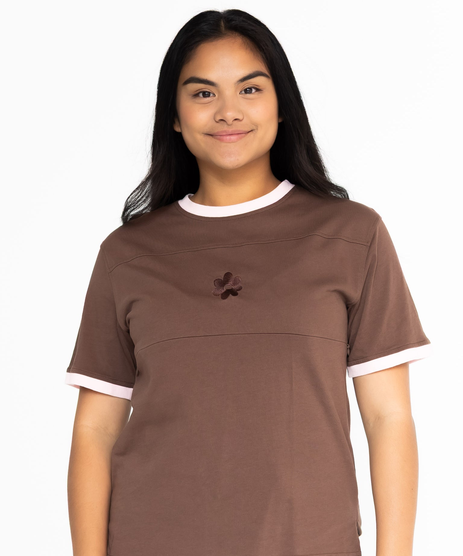 Front view of the Indiana breastfeeding tee in brown with soft pink trim, worn oversized