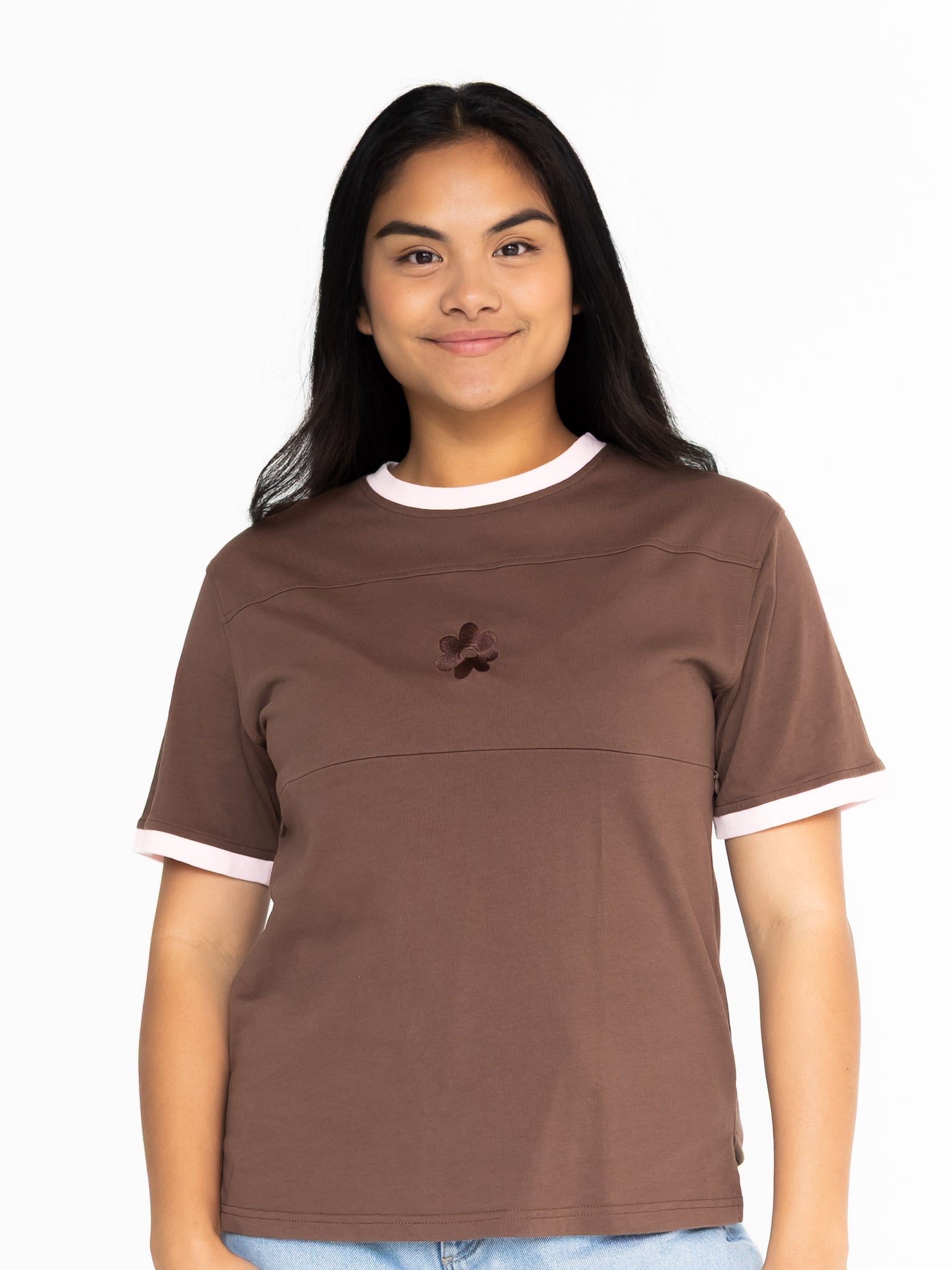Front view of the Indiana breastfeeding tee in brown with soft pink trim, worn oversized