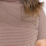 Close-up of the tonal brown chest pocket and zip seam on the brown and white striped Mackenzie tee