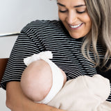 Smiling mum breastfeeding her baby in the black and white striped Mackenzie breastfeeding tee by Milky Threads Co