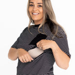 Smiling mum opening the two-way zip on the striped Mackenzie breastfeeding tee