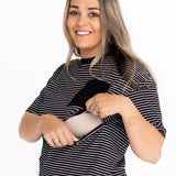 Smiling mum opening the two-way zip on the striped Mackenzie breastfeeding tee