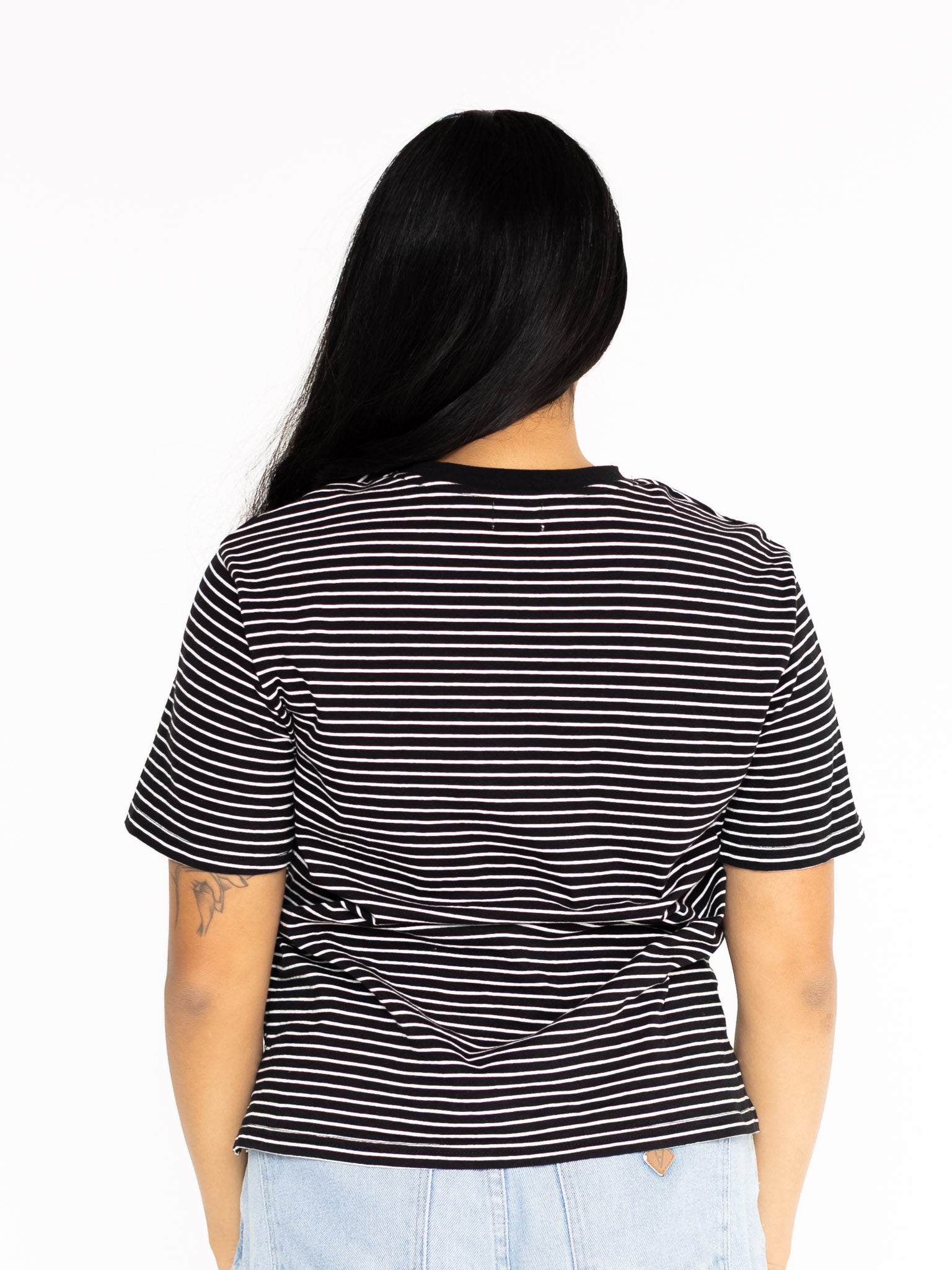 Back view of the black and white striped Mackenzie boyfriend tee